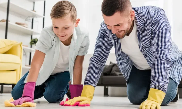 A kid cleaning his room