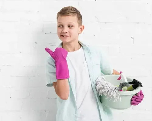 A kid with cleaning supplies